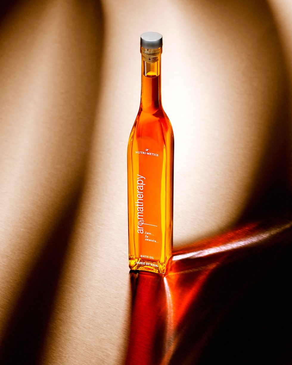 Calgary Commercial Photography. Aromatherapy bath oil with divine light refraction.