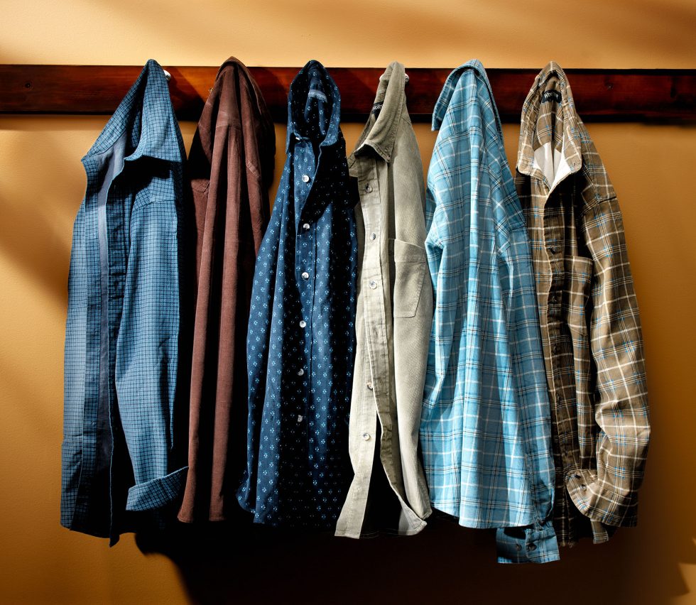 Calgary Product Photographer. Assortment of hanging mens dress shirts and flannels.